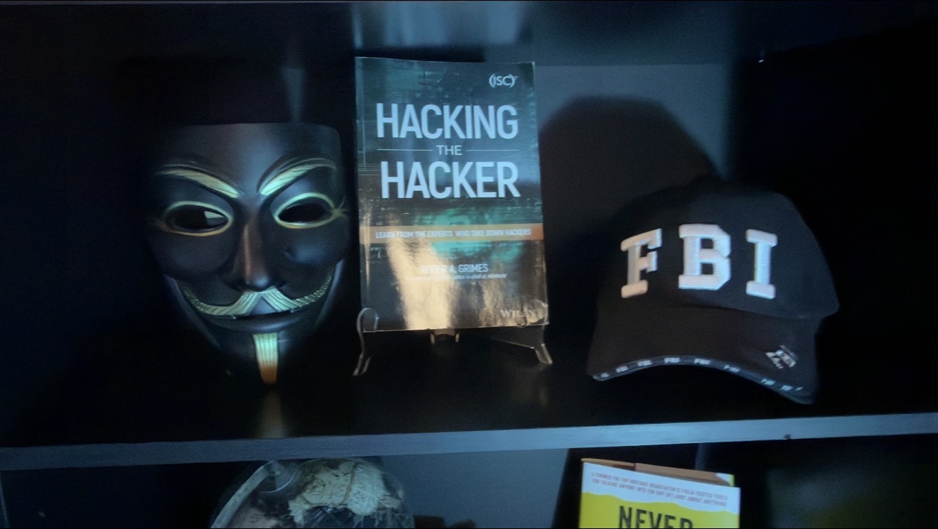 Cyber Crime Junkies studio shelf with Hacking the Hacker
